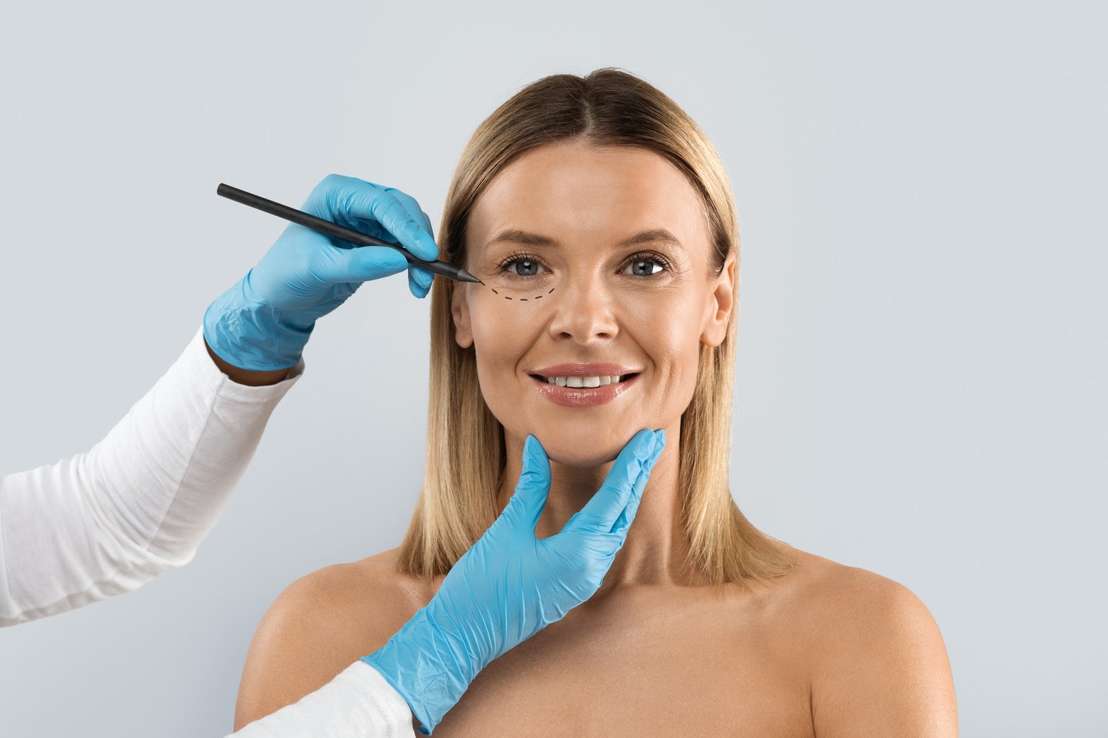 surgeon-drawing-perforation-lines-on-woman-face-for-plastic-surgery.jpg surgeon-drawing-perforation-lines-on-woman-face-for-plastic-surgery.jpg